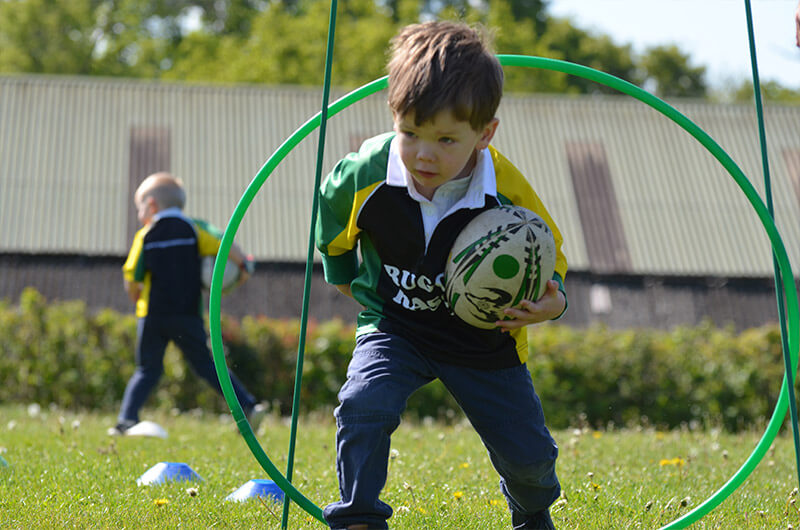 little boy enjoying a rugby training